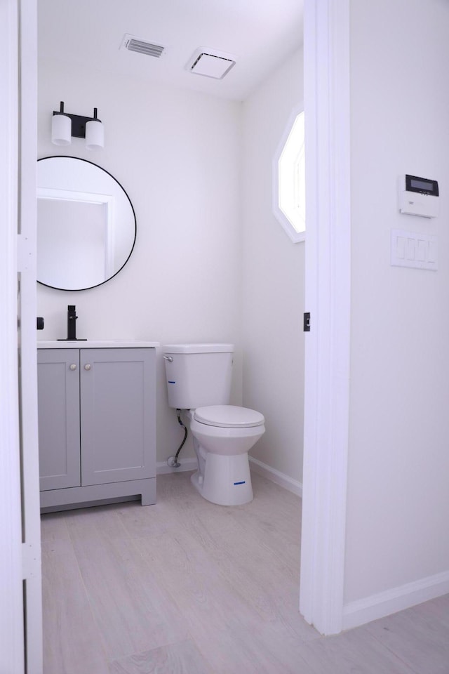 2012 White Coral Ct, Wellington, FL 33414 - bathroom with vanity, toilet, baseboards, and wood finished floors