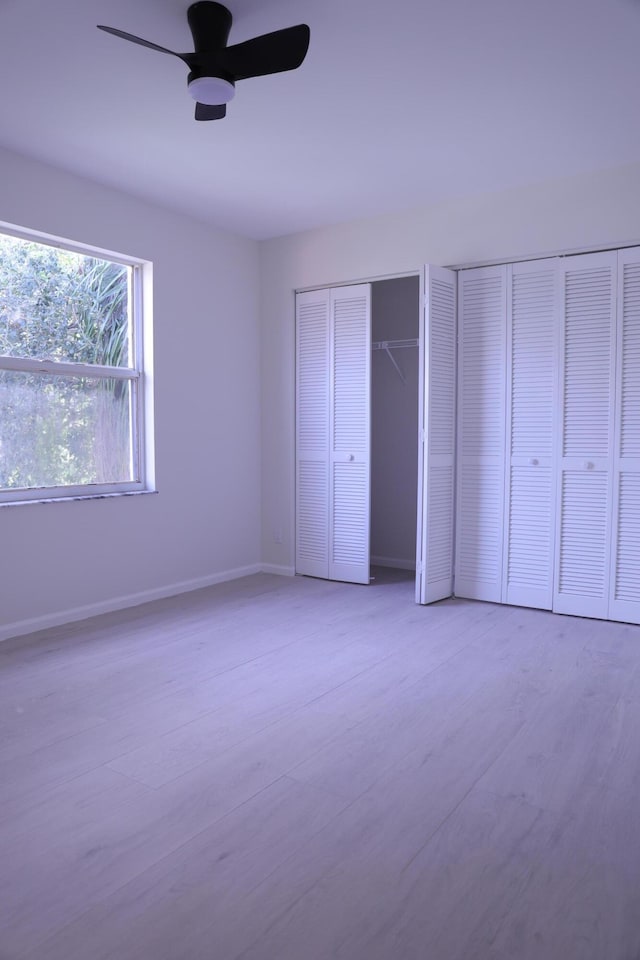 2012 White Coral Ct, Wellington, FL 33414 - unfurnished bedroom with multiple closets, a ceiling fan, and baseboards
