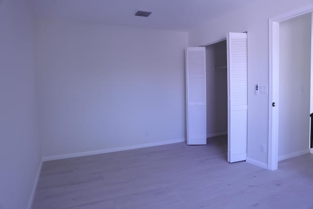 2012 White Coral Ct, Wellington, FL 33414 - unfurnished bedroom featuring wood finished floors, baseboards, and a closet