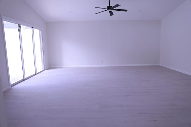 2012 White Coral Ct, Wellington, FL 33414 - spare room with healthy amount of natural light, light wood-style floors, a ceiling fan, lofted ceiling, and baseboards