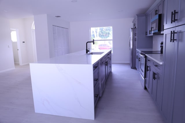 2012 White Coral Ct, Wellington, FL 33414 - kitchen featuring appliances with stainless steel finishes, a sink, an island with sink, and plenty of natural light