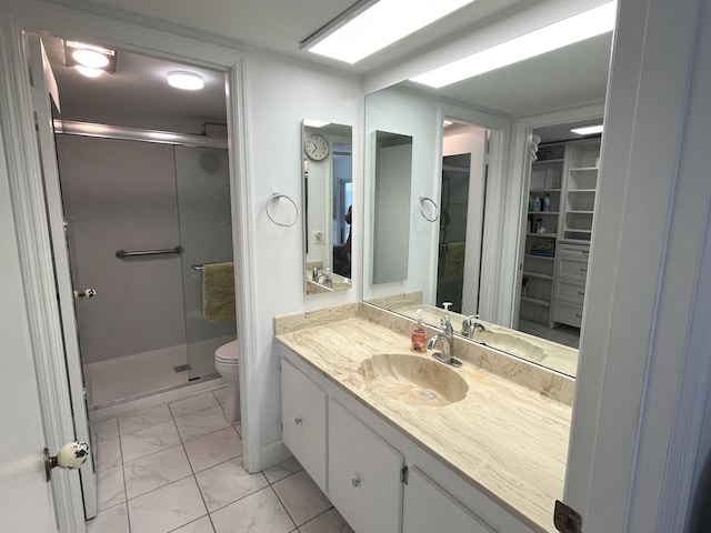 308 Golfview Rd Unit 107, North Palm Beach, FL 33408 - bathroom with marble look tile flooring, a shower stall, vanity, toilet, and a walk in closet
