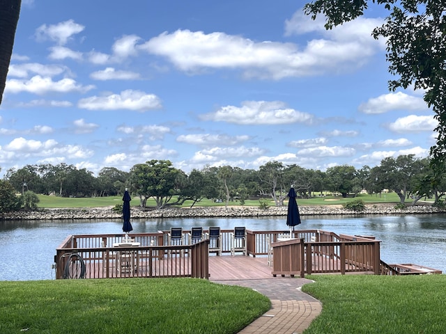 308 Golfview Rd Unit 107, North Palm Beach, FL 33408 - dock area with a lawn, a water view, and view of wooded area