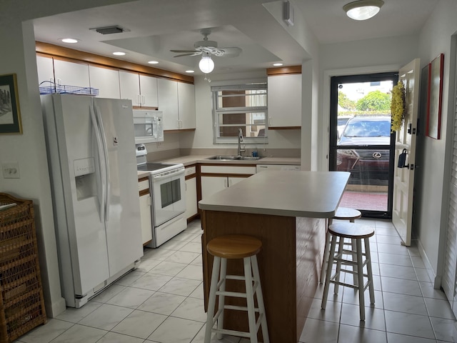 308 Golfview Rd Unit 107, North Palm Beach, FL 33408 - kitchen with white appliances, a sink, a kitchen bar, white cabinetry, and recessed lighting