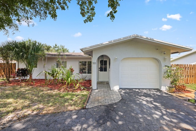 513 Curlew Rd, Delray Beach, FL 33444 - ranch-style house with stucco siding, asphalt driveway, and a garage
