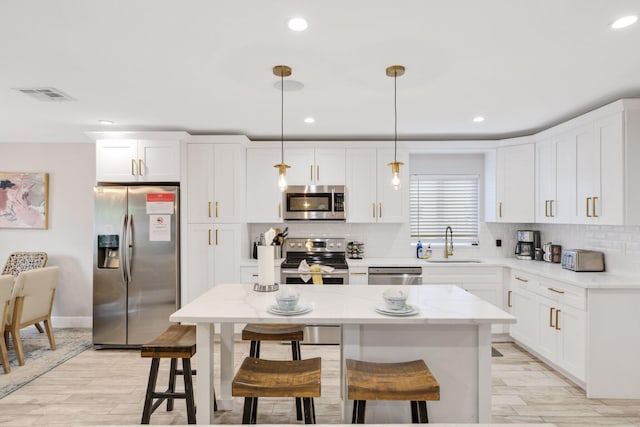 513 Curlew Rd, Delray Beach, FL 33444 - kitchen with appliances with stainless steel finishes, a sink, backsplash, white cabinetry, and recessed lighting
