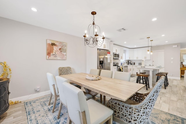 513 Curlew Rd, Delray Beach, FL 33444 - dining area with recessed lighting, baseboards, a chandelier, and light wood finished floors
