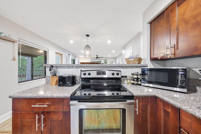 1646 NE 3rd Ave, Delray Beach, FL 33444 - kitchen featuring appliances with stainless steel finishes, light stone counters, a peninsula, decorative light fixtures, and recessed lighting