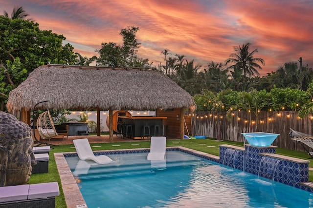 1646 NE 3rd Ave, Delray Beach, FL 33444 - pool at dusk with a jacuzzi, a gazebo, and a patio area