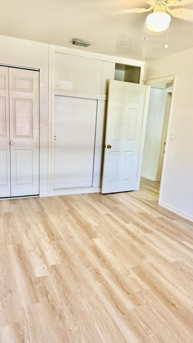 629 Troy Blvd, West Palm Beach, FL 33409 - unfurnished bedroom featuring light wood finished floors, baseboards, and ceiling fan