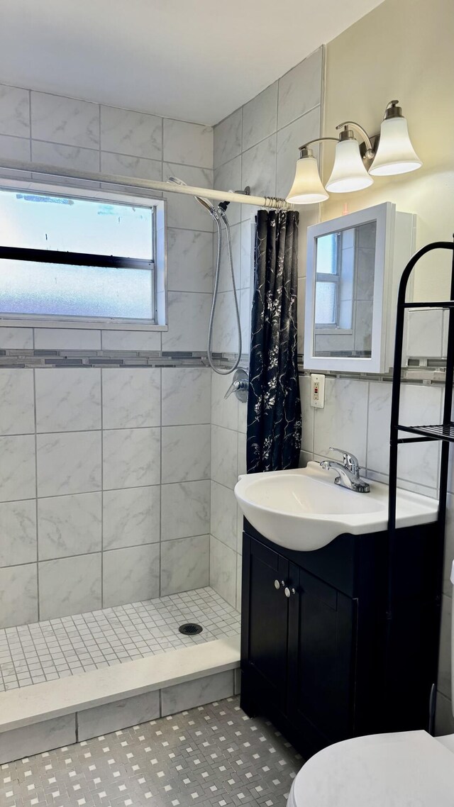 629 Troy Blvd, West Palm Beach, FL 33409 - full bath with plenty of natural light, tiled shower, and vanity