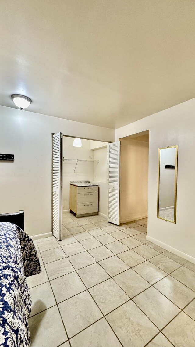 629 Troy Blvd, West Palm Beach, FL 33409 - bedroom featuring light tile patterned floors and baseboards