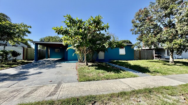 629 Troy Blvd, West Palm Beach, FL 33409 - obstructed view of property featuring driveway and an attached carport