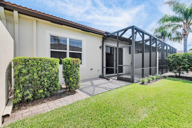 14811 Via Porta, Delray Beach, FL 33446 - rear view of property featuring a patio, a yard, stucco siding, a tile roof, and a lanai