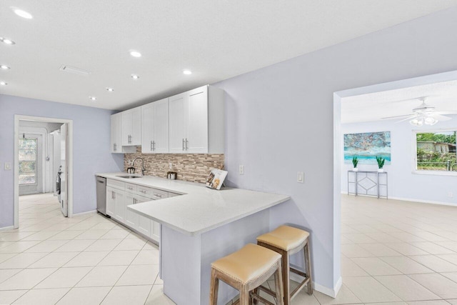 3187 Buccaneer Rd, Lake Worth, FL 33462 - kitchen with a kitchen bar, dishwasher, recessed lighting, light countertops, and backsplash