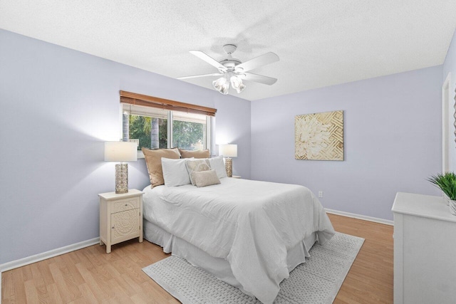 3187 Buccaneer Rd, Lake Worth, FL 33462 - bedroom featuring baseboards, light wood-type flooring, a ceiling fan, and a textured ceiling
