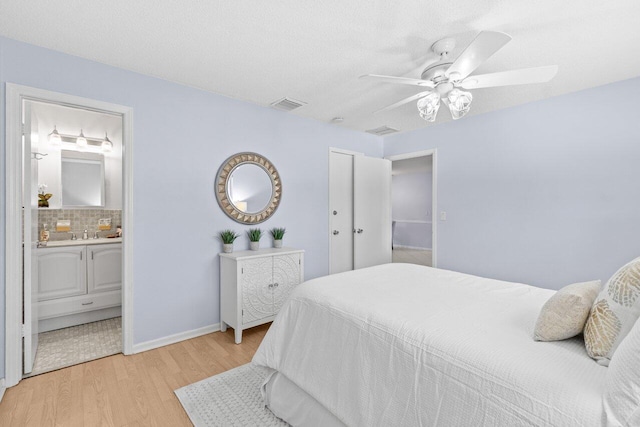 3187 Buccaneer Rd, Lake Worth, FL 33462 - bedroom featuring light wood finished floors, ensuite bathroom, ceiling fan, and baseboards