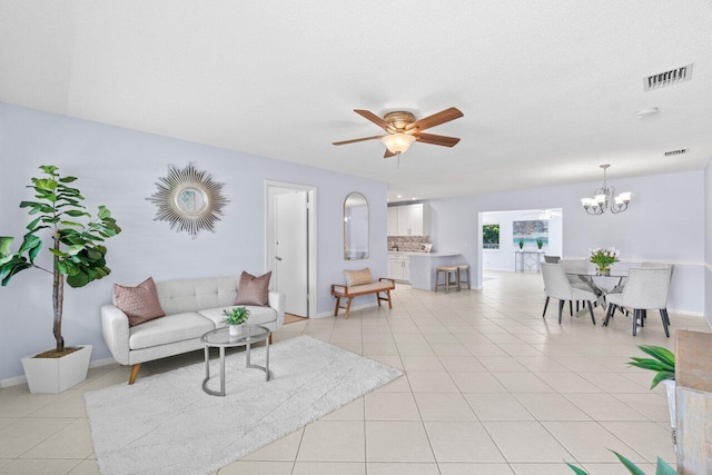 3187 Buccaneer Rd, Lake Worth, FL 33462 - living area with light tile patterned floors, a ceiling fan, a chandelier, and baseboards