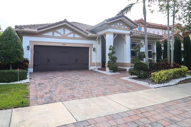 8581 Waterside Ct, Parkland, FL 33076 - view of front facade with stucco siding, a garage, decorative driveway, and a tiled roof