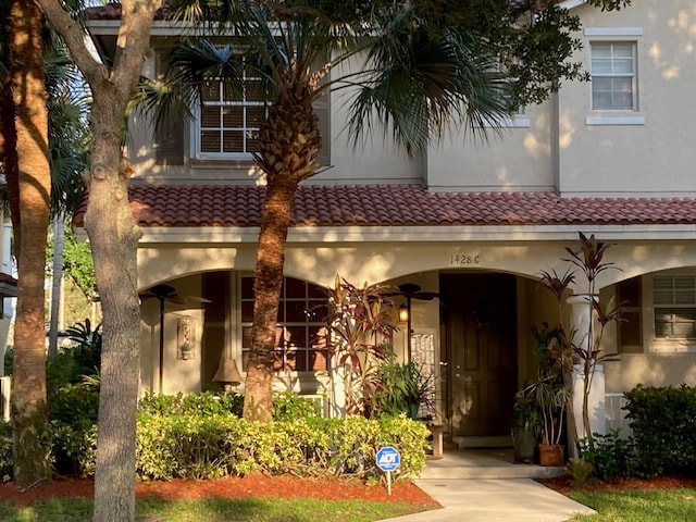 1428 W Wickham C Cir Unit C, Delray Beach, FL 33445 - view of front of home featuring stucco siding, a tiled roof, and covered porch