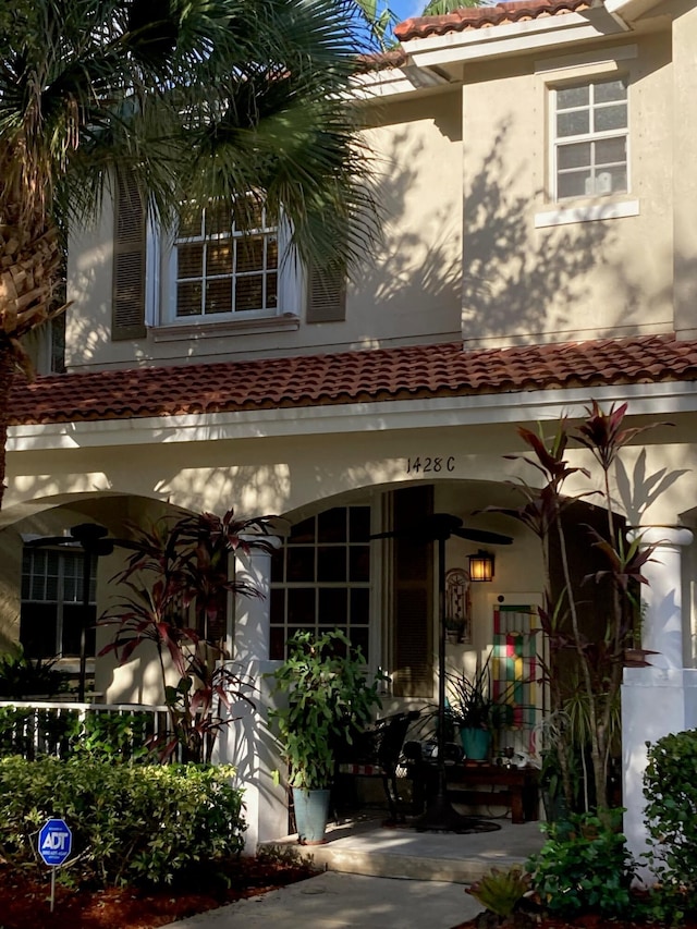 1428 W Wickham C Cir Unit C, Delray Beach, FL 33445 - view of exterior entry featuring a tile roof and stucco siding
