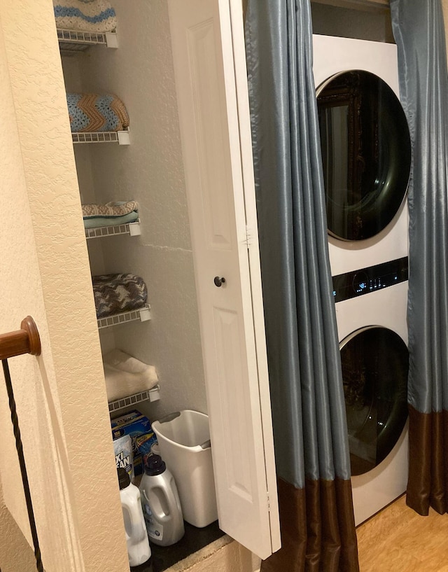 1428 W Wickham C Cir Unit C, Delray Beach, FL 33445 - laundry room featuring stacked washer and clothes dryer and a textured wall