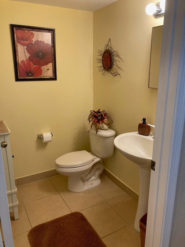 1428 W Wickham C Cir Unit C, Delray Beach, FL 33445 - bathroom featuring tile patterned floors, toilet, and baseboards