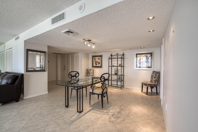 4200 N Ocean Dr Unit 1-1405, Singer Island, FL 33404 - dining room featuring a textured ceiling, light tile patterned flooring, baseboards, and healthy amount of natural light