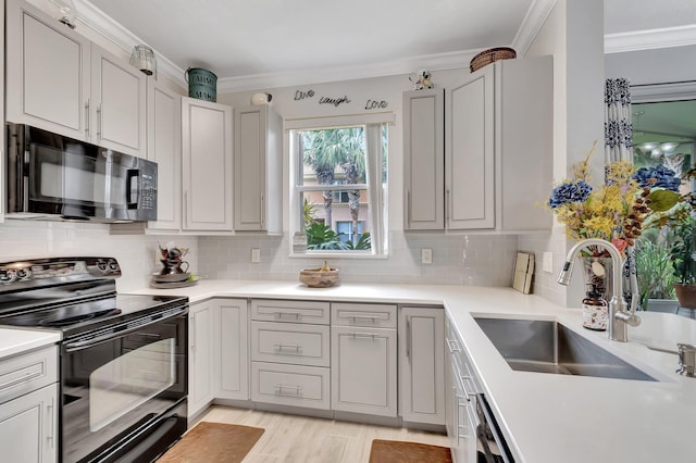 212 River Bluff Ln, Royal Palm Beach, FL 33411 - kitchen featuring black appliances, a sink, backsplash, ornamental molding, and light countertops