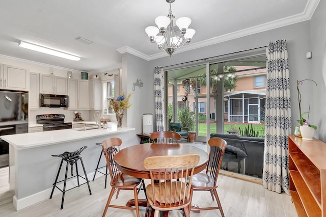 212 River Bluff Ln, Royal Palm Beach, FL 33411 - dining area featuring ornamental molding, light wood finished floors, and a chandelier