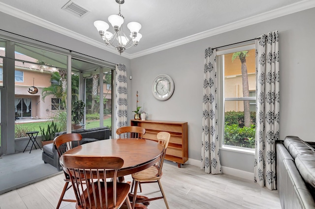 212 River Bluff Ln, Royal Palm Beach, FL 33411 - dining room featuring plenty of natural light, a chandelier, ornamental molding, baseboards, and light wood-style floors