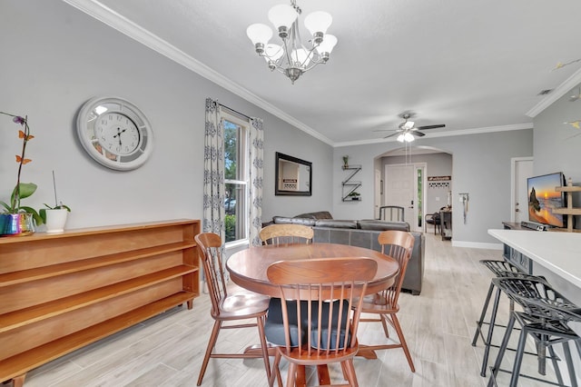 212 River Bluff Ln, Royal Palm Beach, FL 33411 - dining area with crown molding, a chandelier, light wood finished floors, a ceiling fan, and baseboards