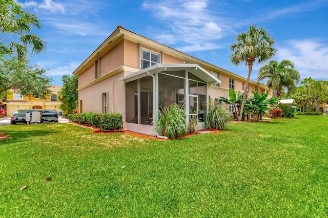 212 River Bluff Ln, Royal Palm Beach, FL 33411 - rear view of house with stucco siding, a sunroom, and a yard