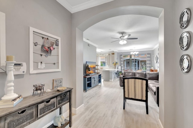 212 River Bluff Ln, Royal Palm Beach, FL 33411 - living area with ornamental molding, a ceiling fan, arched walkways, light wood-style flooring, and baseboards