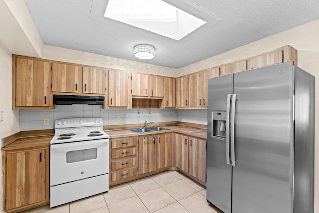 5082 Grant Ln, West Palm Beach, FL 33415 - kitchen with stainless steel fridge, white electric stove, under cabinet range hood, a sink, and light brown cabinets