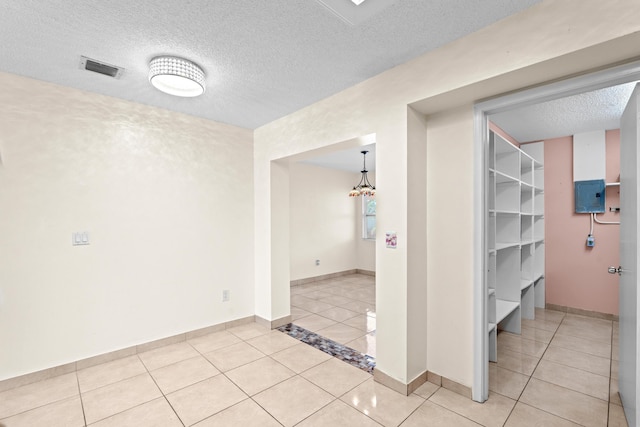5082 Grant Ln, West Palm Beach, FL 33415 - unfurnished room with light tile patterned flooring, a textured ceiling, and baseboards