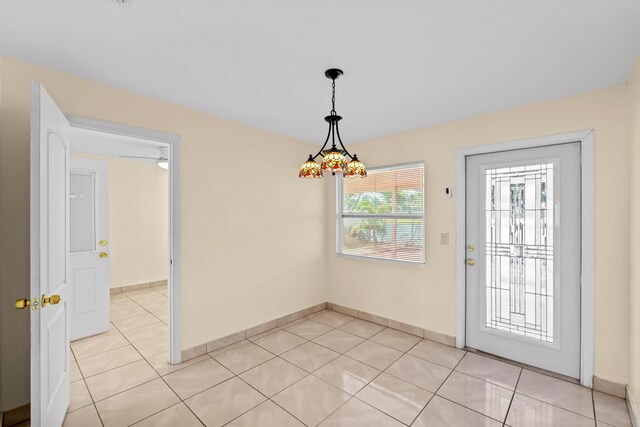 5082 Grant Ln, West Palm Beach, FL 33415 - unfurnished dining area featuring light tile patterned flooring and baseboards