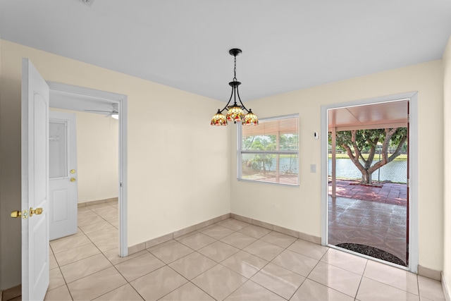 5082 Grant Ln, West Palm Beach, FL 33415 - unfurnished room featuring light tile patterned floors, baseboards, and a water view