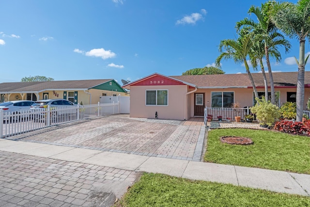 5082 Grant Ln, West Palm Beach, FL 33415 - ranch-style house with stucco siding and driveway