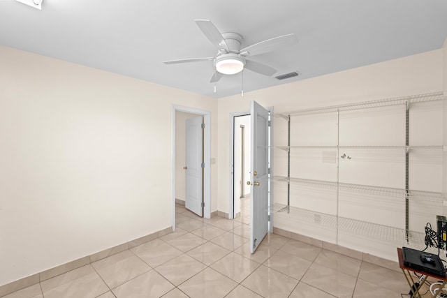 5082 Grant Ln, West Palm Beach, FL 33415 - unfurnished bedroom featuring baseboards, light tile patterned floors, and ceiling fan