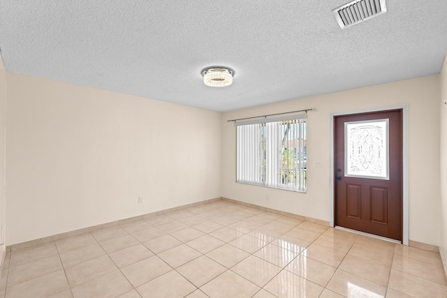 5082 Grant Ln, West Palm Beach, FL 33415 - foyer entrance featuring light tile patterned floors, a textured ceiling, and baseboards