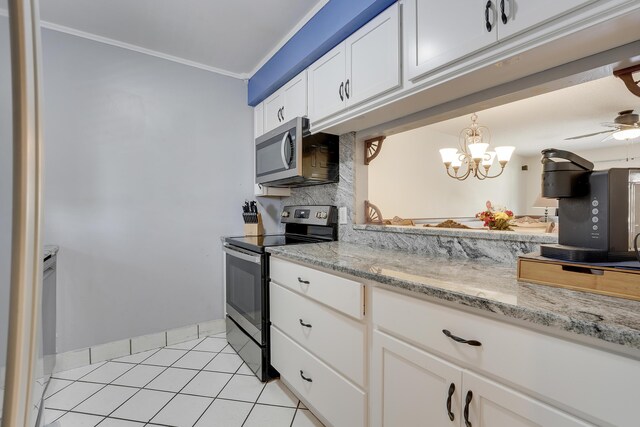 12027 Greenway Cir S Unit 204, Royal Palm Beach, FL 33411 - kitchen featuring stainless steel appliances, light tile patterned floors, ornamental molding, white cabinetry, and light stone counters