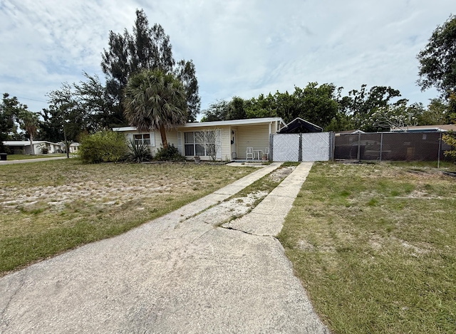 3901 Neptune Dr SE, Saint Petersburg, FL 33705 - view of front facade featuring concrete driveway and a gate