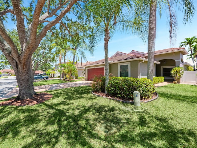 6287 Grand Cypress Cir, Lake Worth, FL 33463 - view of front of home with stucco siding, an attached garage, and driveway