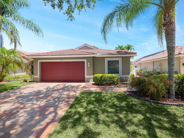 6287 Grand Cypress Cir, Lake Worth, FL 33463 - ranch-style home with a tile roof, a garage, stucco siding, concrete driveway, and a front yard
