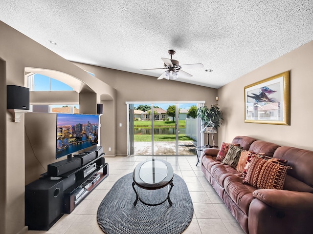 6287 Grand Cypress Cir, Lake Worth, FL 33463 - living area with plenty of natural light, light tile patterned floors, a ceiling fan, vaulted ceiling, and a textured ceiling