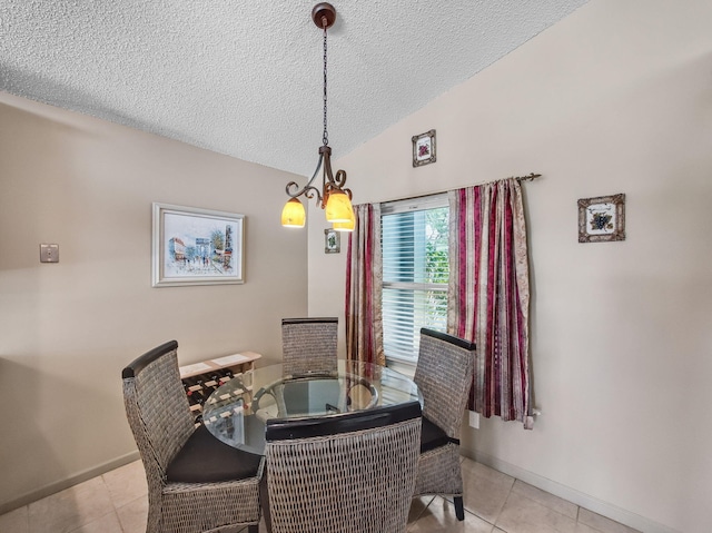 6287 Grand Cypress Cir, Lake Worth, FL 33463 - dining area with a textured ceiling, light tile patterned floors, lofted ceiling, a chandelier, and baseboards