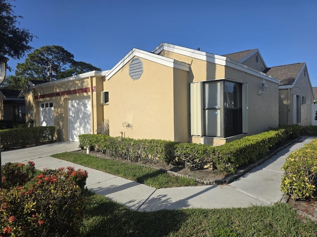 4580 Discovery Ln Unit 23, West Palm Beach, FL 33417 - view of home's exterior featuring an attached garage and stucco siding