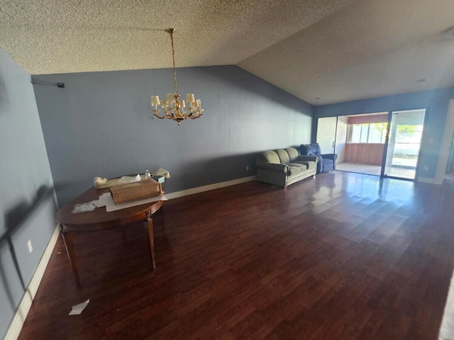 4580 Discovery Ln Unit 23, West Palm Beach, FL 33417 - living area with wood finished floors, a textured ceiling, vaulted ceiling, baseboards, and a chandelier