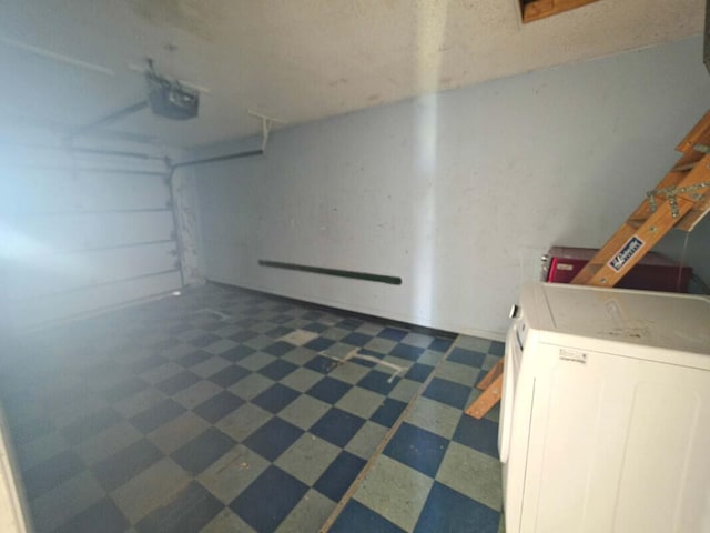 4580 Discovery Ln Unit 23, West Palm Beach, FL 33417 - garage with washer / dryer and a garage door opener